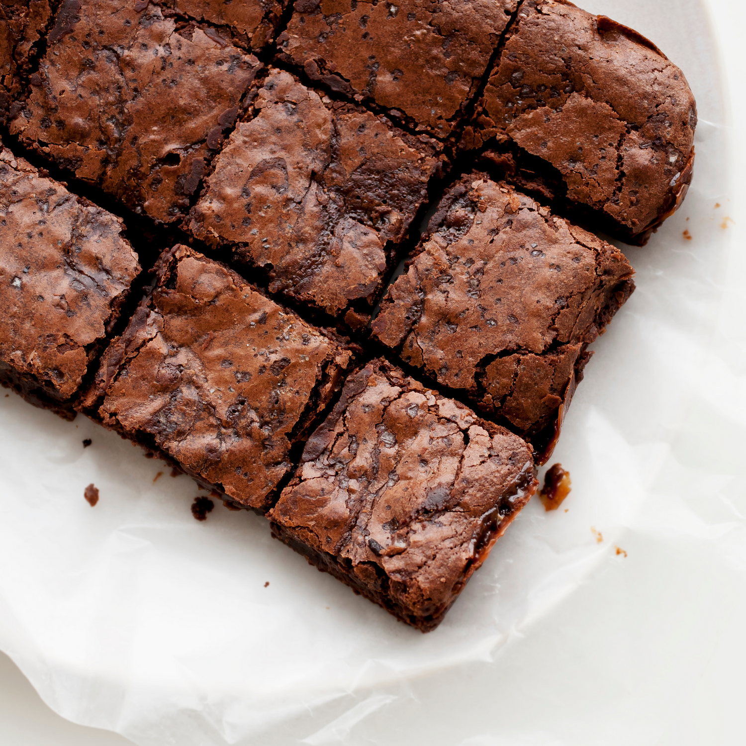 Brownies cut into squares on a white surface