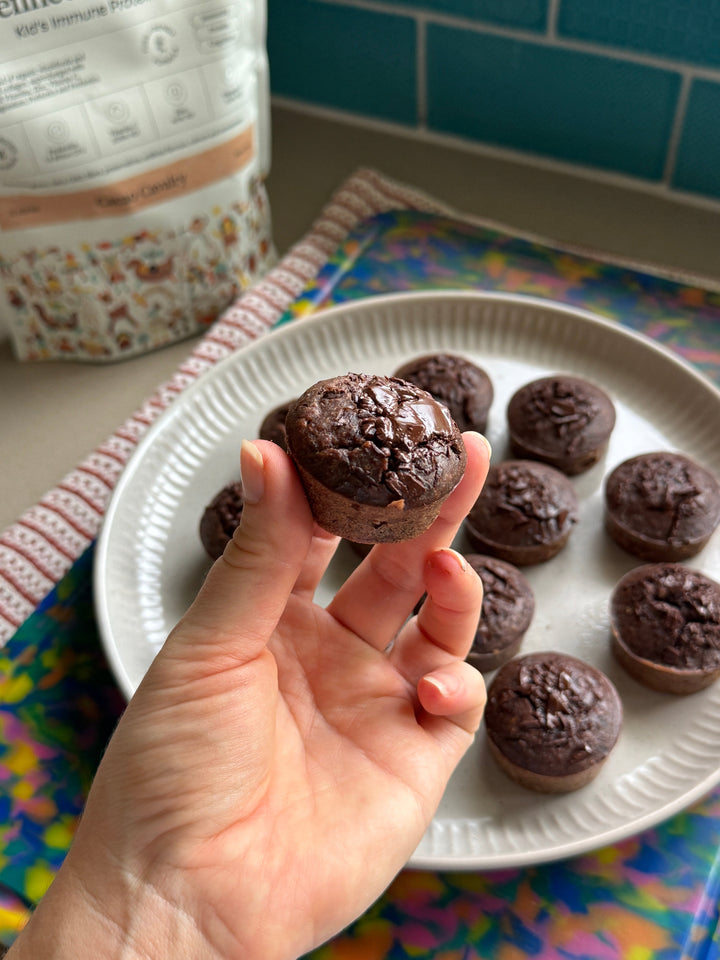 Mini black bean brownies on a plate with Kids Immune Protein Cacao Cavalry behind