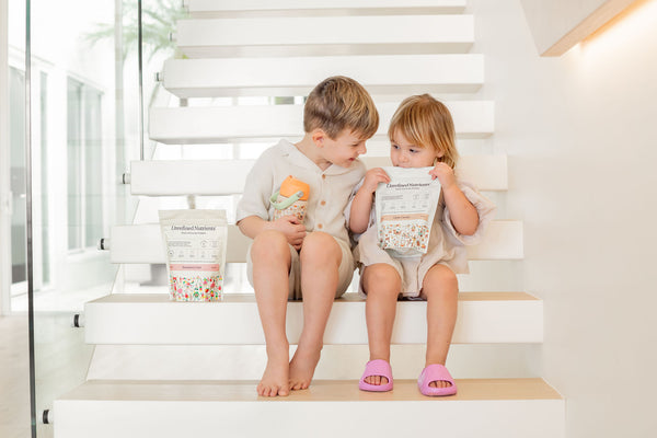 Two kids on the stairs with Kids Immune Protein